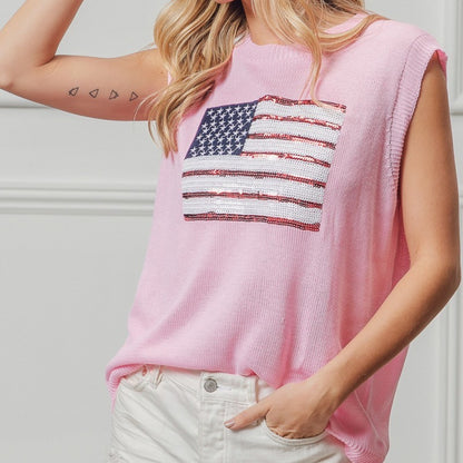 Person wearing a pink sleeveless top with an American flag design.