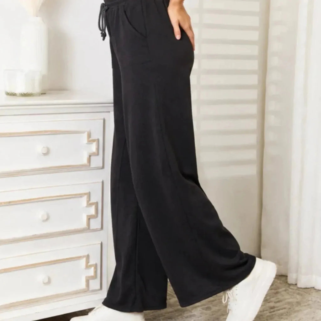 Side view of black wide leg lounge pants with a relaxed silhouette and comfortable fit.