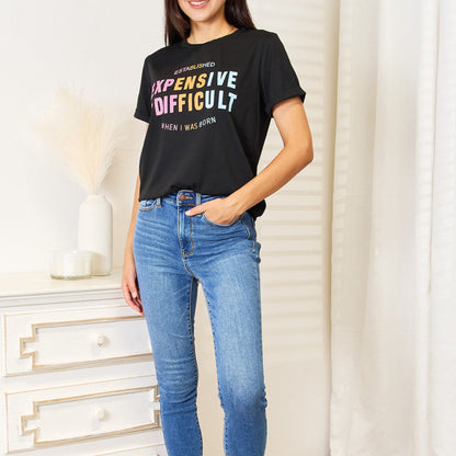 Folded black graphic t-shirt highlighting the cuffed sleeves and neck.
