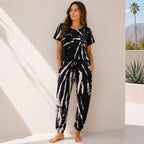 Women's black tie-dye two-piece lounge set with short sleeve top and matching jogger pants.