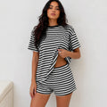 Woman wearing classic black and white horizontal striped short-sleeve top and shorts lounge set