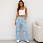 Woman wearing blue and white striped drawstring straight-leg pants with pockets