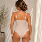 Women's nude bodysuit shapewear back view featuring adjustable straps, seamless design, and full back coverage for everyday shaping comfort.