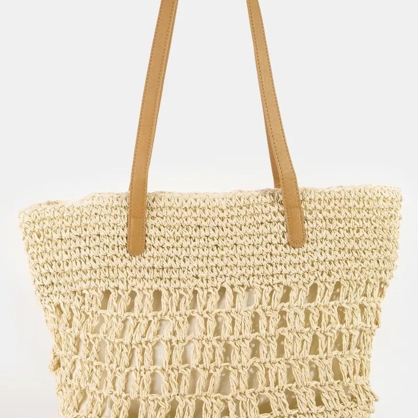 Spacious Ivory woven straw beach bag showcasing the intricate braided texture and design.