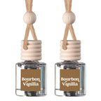 Two reed diffuser bottles with clear glass bodies, beige wooden caps, and tan hanging cords, each labeled Bourbon Vanilla on a white background.