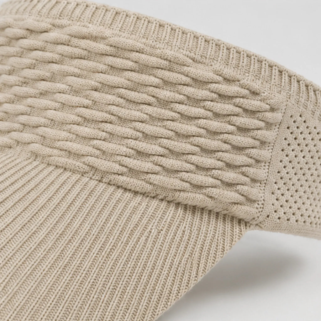 Close-up of the khaki knit sun visor highlighting the textured cable knit pattern, breathable mesh sides, and curved brim.
