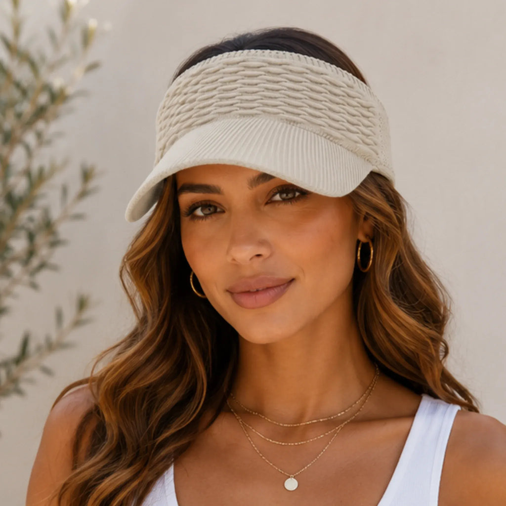 Woman wearing the breathable knit sun visor hat in khaki featuring a cable knit texture, curved brim, and open-top design.