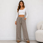 Woman wearing brown and white striped drawstring straight-leg pants with pockets