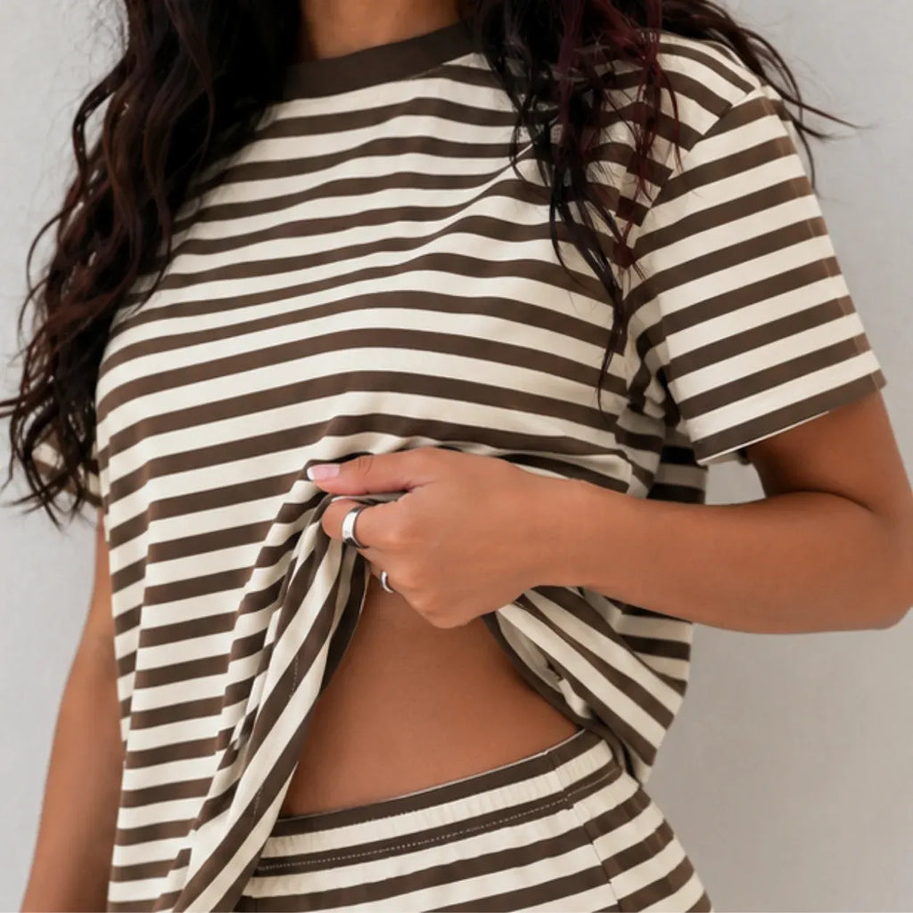 Close-up view of elastic waistband and hem detail on brown striped lounge shorts set