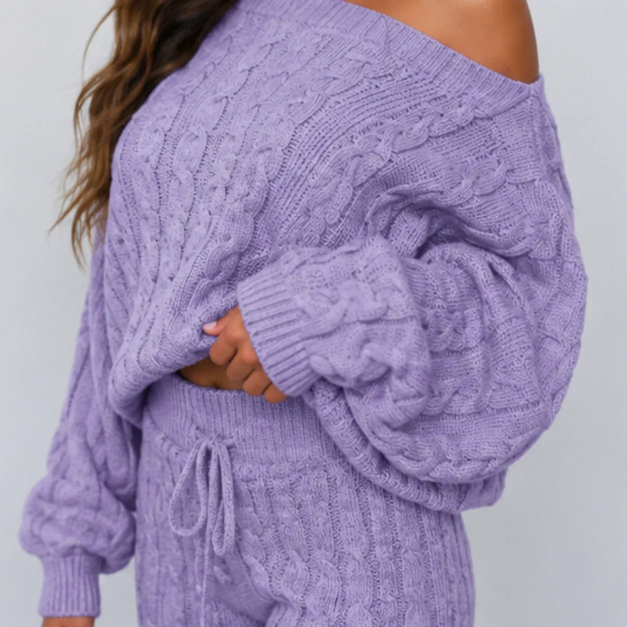 Close-up view of light purple cable knit sweater and pants set showing knit texture