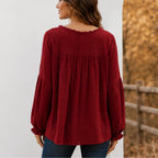 Back view of the women's wine red Casual Long Sleeve Fringe Tassel Top showcasing the relaxed babydoll silhouette, gathered back yoke, textured fabric, and long sleeves.