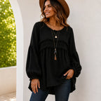 Women's black Casual Long Sleeve Fringe Tassel Top featuring textured woven fabric, fringe tassel trim, long balloon sleeves, relaxed babydoll fit, and round neckline.