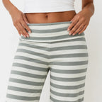 Close-up of light green and white striped wide-leg pants showing the waistband and fabric