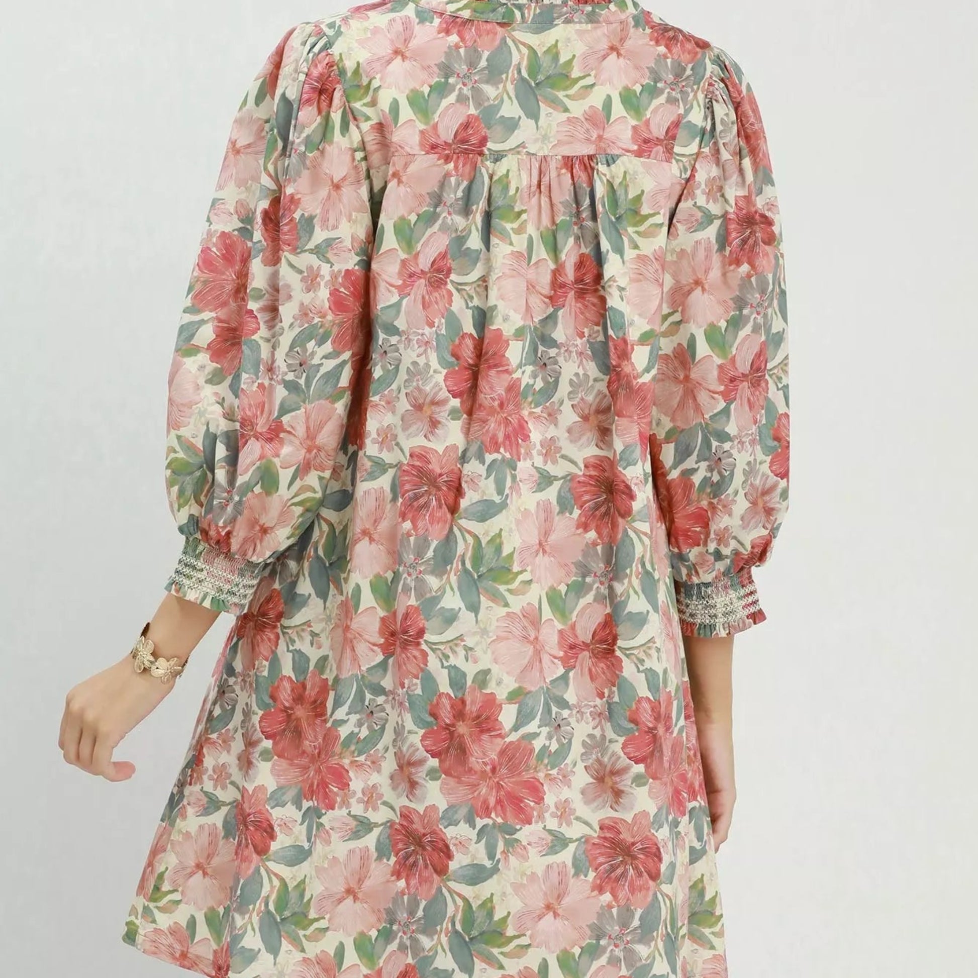 Back view of the breezy mixed floral Umgee mini dress showing rear bodice fit from Solazura Boutique