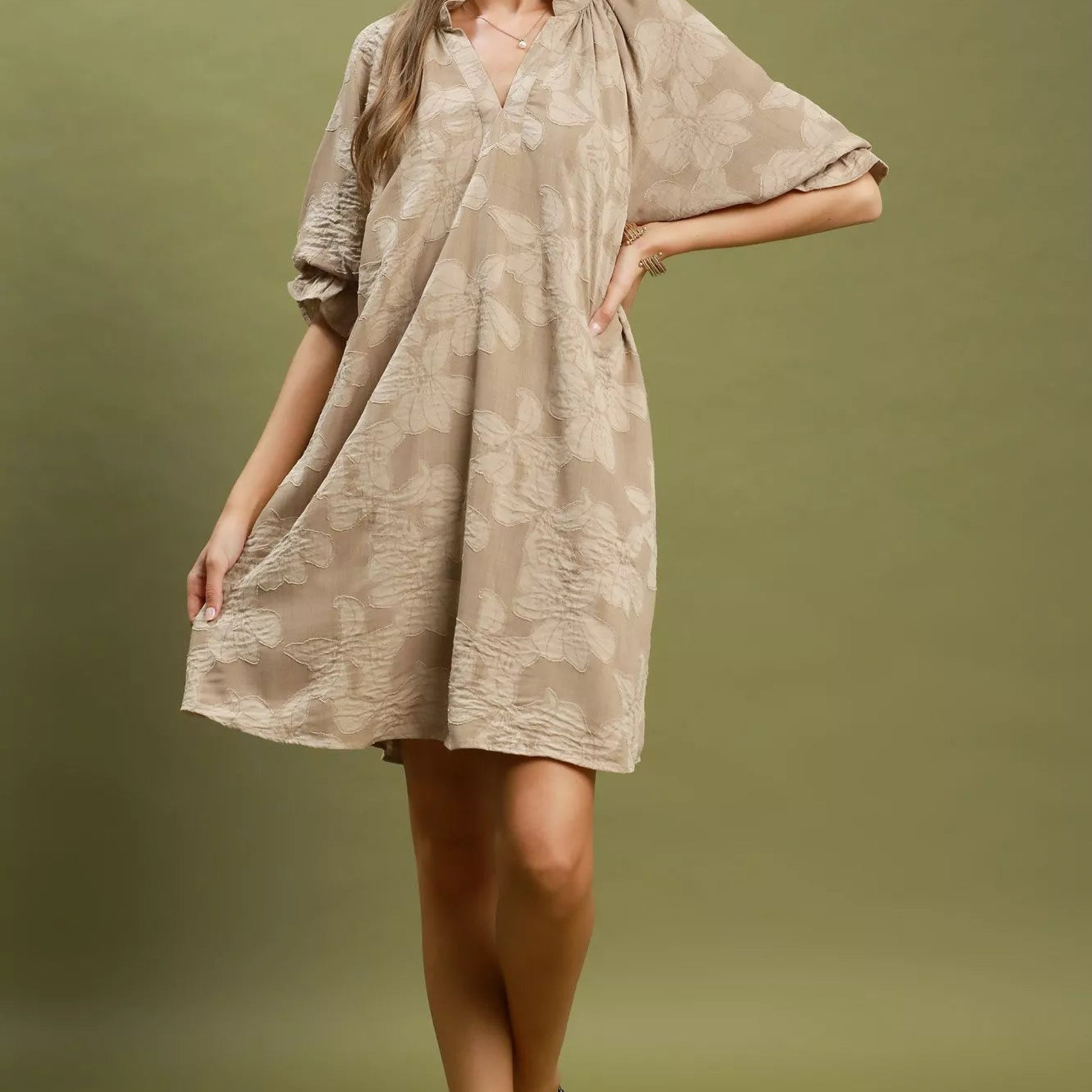 Close up detail of the flattering V-neckline and clean stitching on a taupe Umgee dress from Solazura Boutique