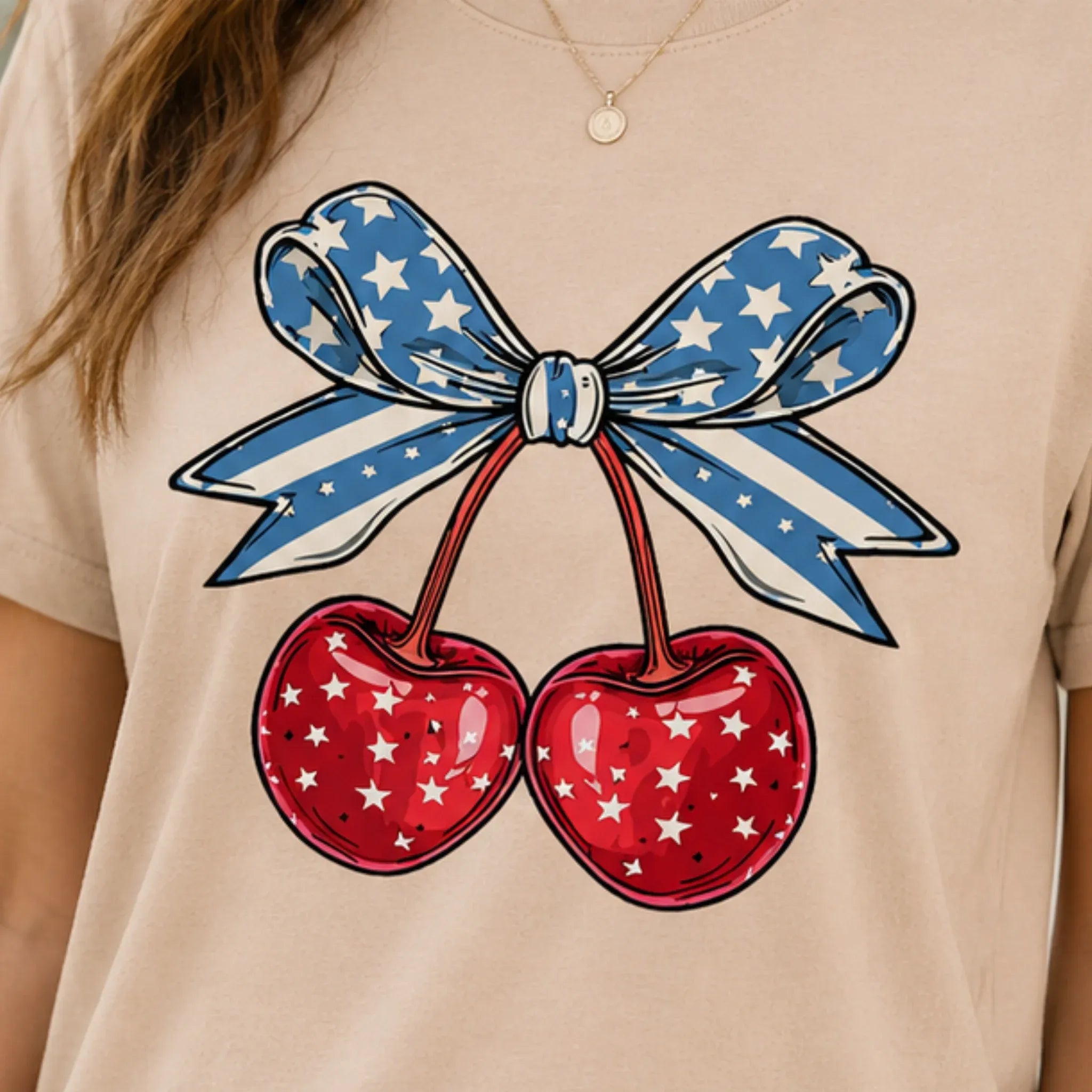 Close-up of the patriotic cherry bow graphic on a beige Cherry Graphic Round Neck Short Sleeve T-Shirt.