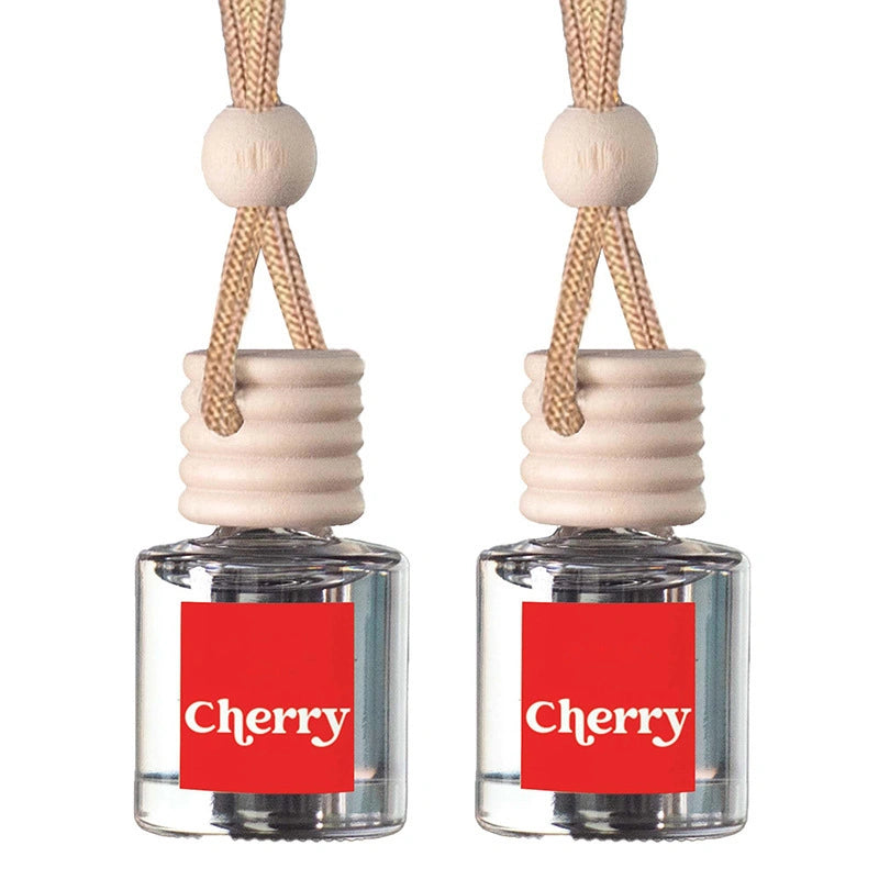 Two cherry scented car air fresheners with clear glass bottles, red labels, and light wood caps on a white background.
