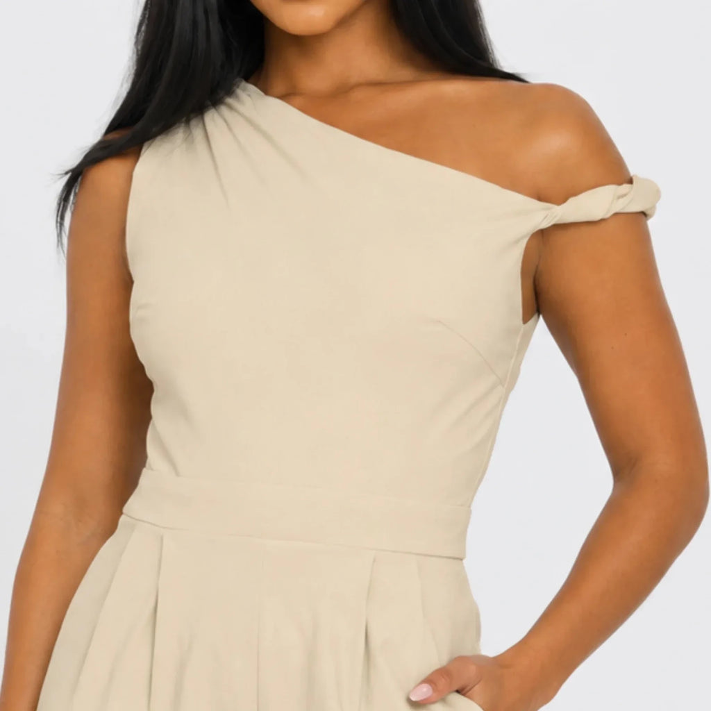 Close-up of the Chic Poise One-Shoulder Jumpsuit in stone highlighting the asymmetrical neckline, structured bodice, and smooth fabric finish.