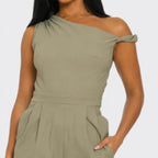 Close-up of the Chic Poise One-Shoulder Jumpsuit in khaki highlighting the asymmetrical neckline, structured bodice, and smooth fabric finish.