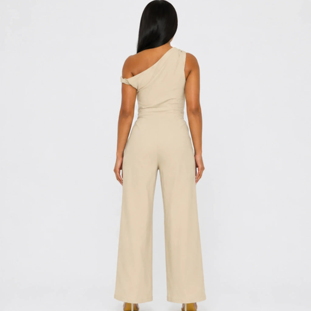 Chic Poise One-Shoulder Jumpsuit in stone featuring an asymmetrical neckline, tailored waist, wide-leg silhouette, and side pockets, front view.