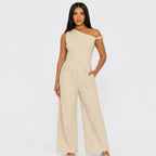 Chic Poise One-Shoulder Jumpsuit in stone featuring an asymmetrical neckline, tailored waist, wide-leg silhouette, and side pockets, front view.