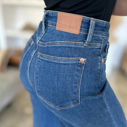Detailed showcase of the medium wash denim texture and pockets.
