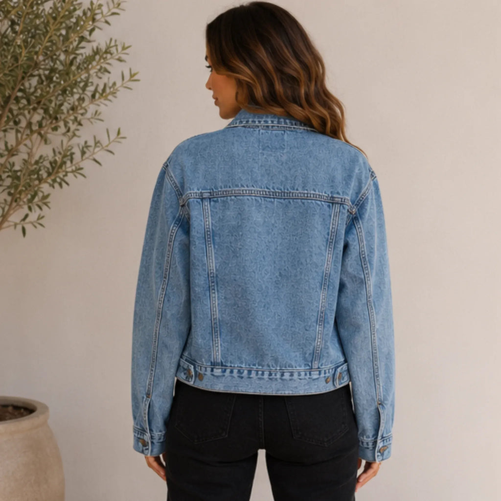 Back view of the women's Classic Loose Fit Denim Jacket in blue featuring a relaxed fit, straight hem, and classic yoke detailing.