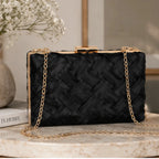 Front view of the Crosshatch Chain Clutch Bag in black featuring an intricate woven satin exterior, gold-tone frame clasp, and detachable chain strap.