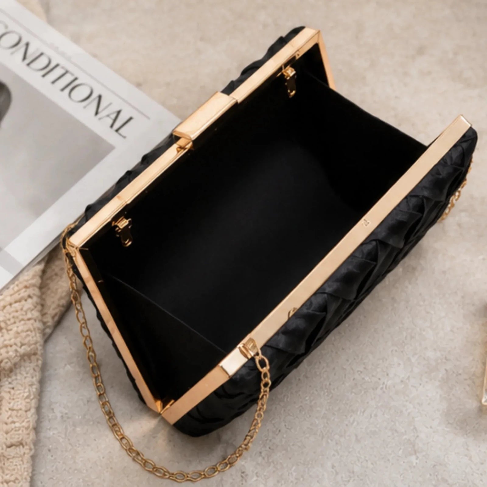 Open interior view of the Crosshatch Chain Clutch Bag in black showcasing the spacious compartment, gold-tone frame closure, and premium lining.