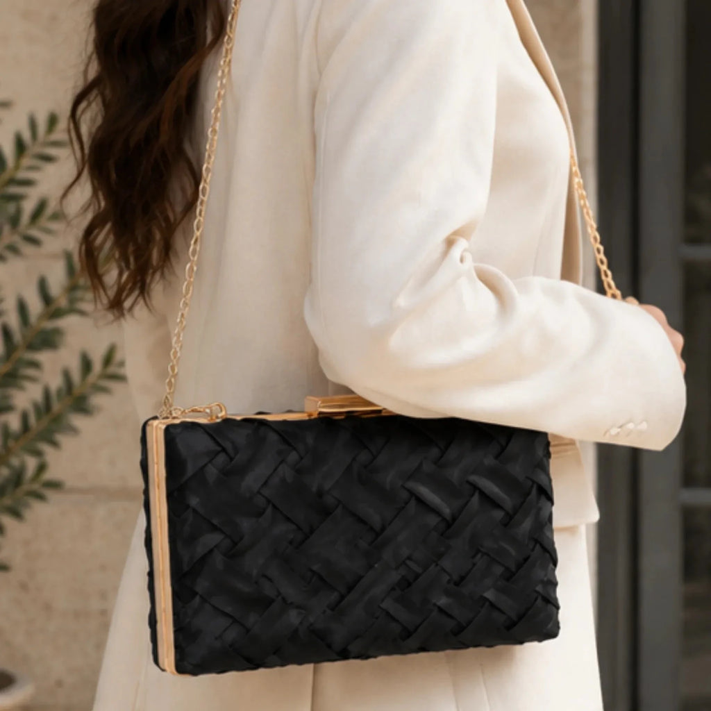 Crosshatch Chain Clutch Bag in black styled as an elegant shoulder bag with a woven satin finish, gold-tone hardware, and detachable chain strap.
