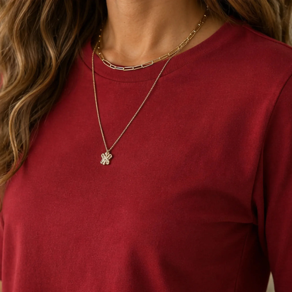 Close-up of red women's crew-neck polyester T-shirt fabric and neckline