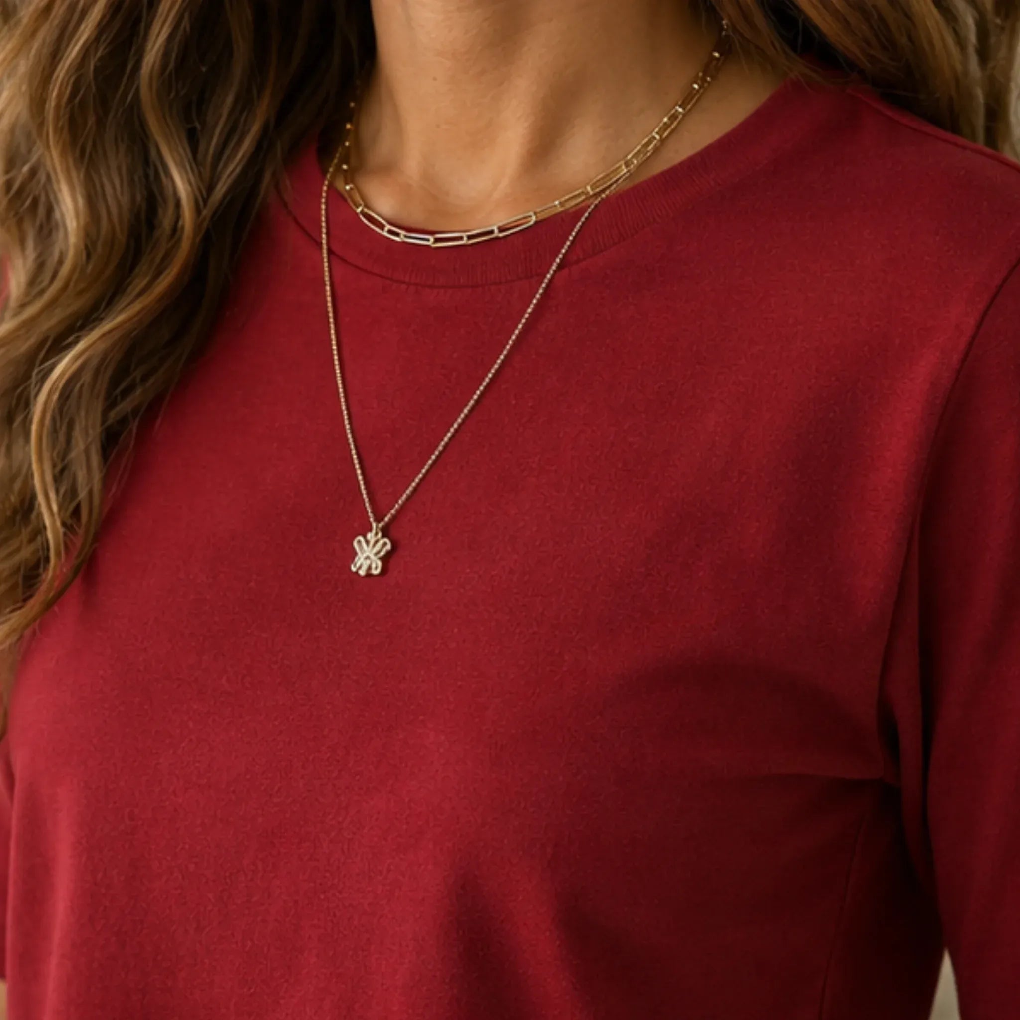 Close-up of red women's crew-neck polyester T-shirt fabric and neckline