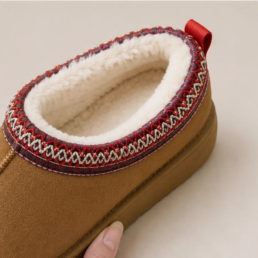 Close-up of brown Cozy Fleece-Lined House Slippers featuring a luxurious fleece lining, embroidered collar detail, and durable platform sole.