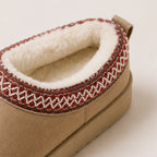 Close-up of khaki Cozy Fleece-Lined House Slippers featuring a plush fleece interior, embroidered collar trim, and soft suede-look exterior.