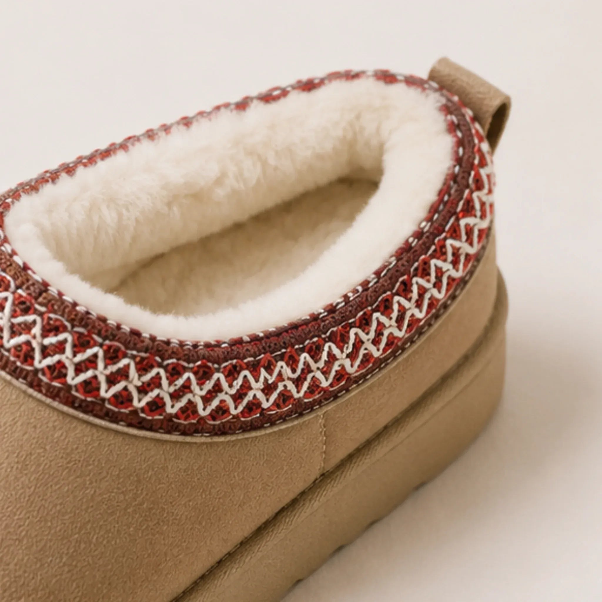 Close-up of khaki Cozy Fleece-Lined House Slippers featuring a plush fleece interior, embroidered collar trim, and soft suede-look exterior.