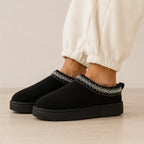 Black Cozy Fleece-Lined House Slippers featuring a soft suede upper, embroidered trim, plush fleece lining, and lightweight platform sole.