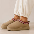 Khaki Cozy Fleece-Lined House Slippers with a suede-look upper, decorative embroidered trim, plush fleece lining, and cushioned platform sole.