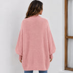 Back view of the women's pink cozy knitted lapel cardigan sweater featuring an oversized silhouette and textured knit finish.