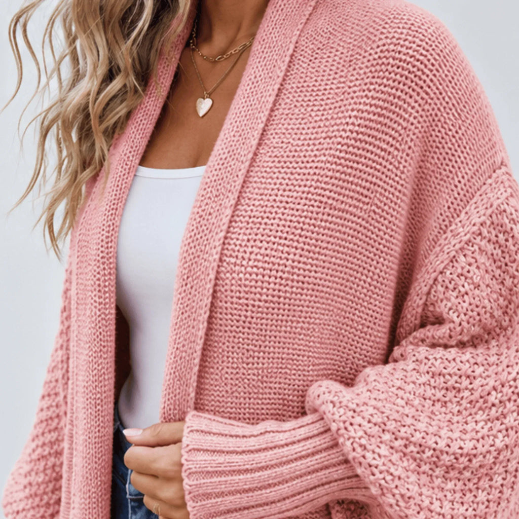 Close-up of the pink cozy knitted lapel cardigan sweater showcasing the textured knit fabric, shawl lapel, and ribbed cuff detail.