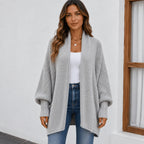 Women's light gray cozy knitted lapel cardigan sweater featuring balloon sleeves, ribbed cuffs, and a relaxed fit.