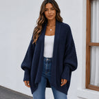 Women's navy blue oversized knitted lapel cardigan sweater with an open front, textured knit, and cozy silhouette.