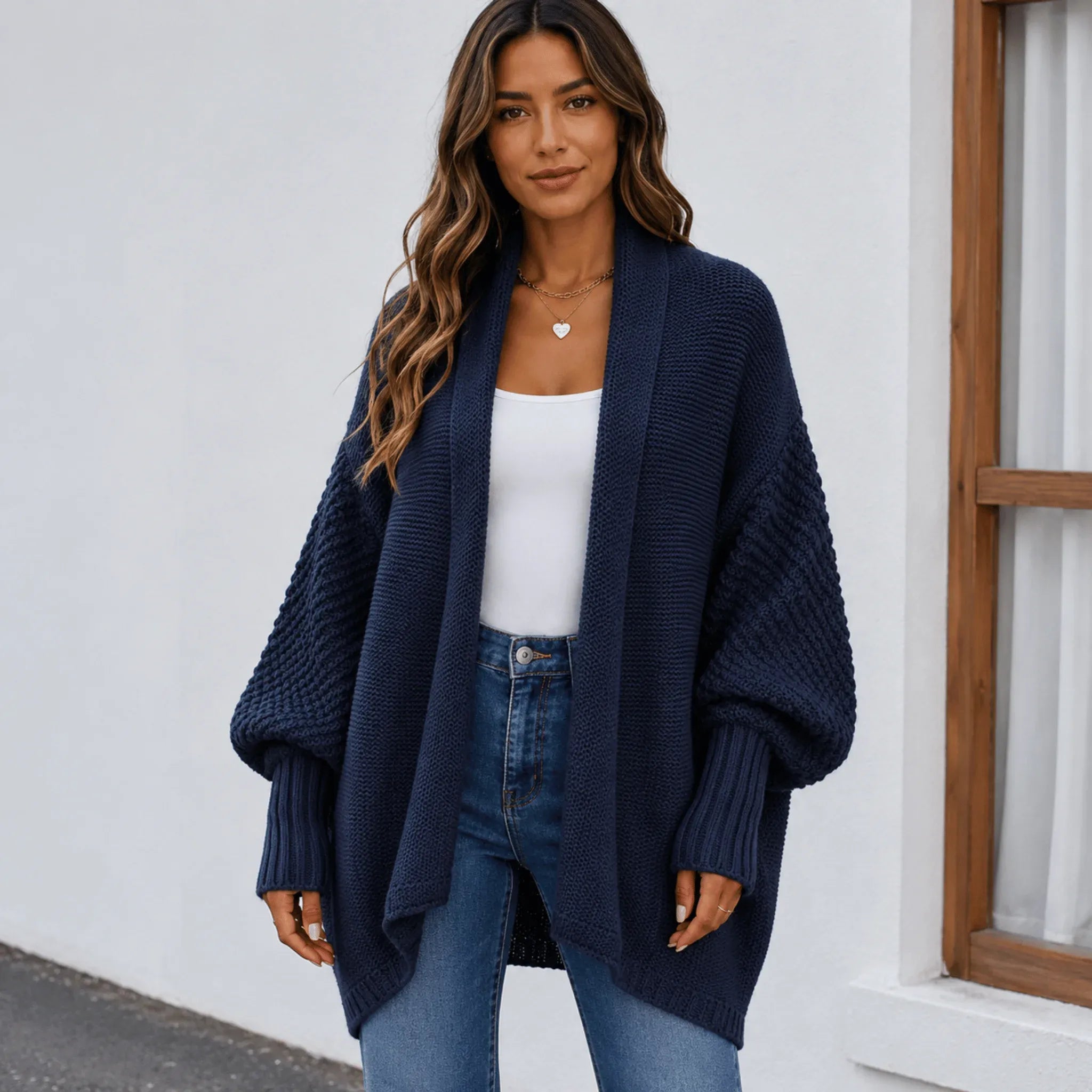 Women's navy blue oversized knitted lapel cardigan sweater with an open front, textured knit, and cozy silhouette.
