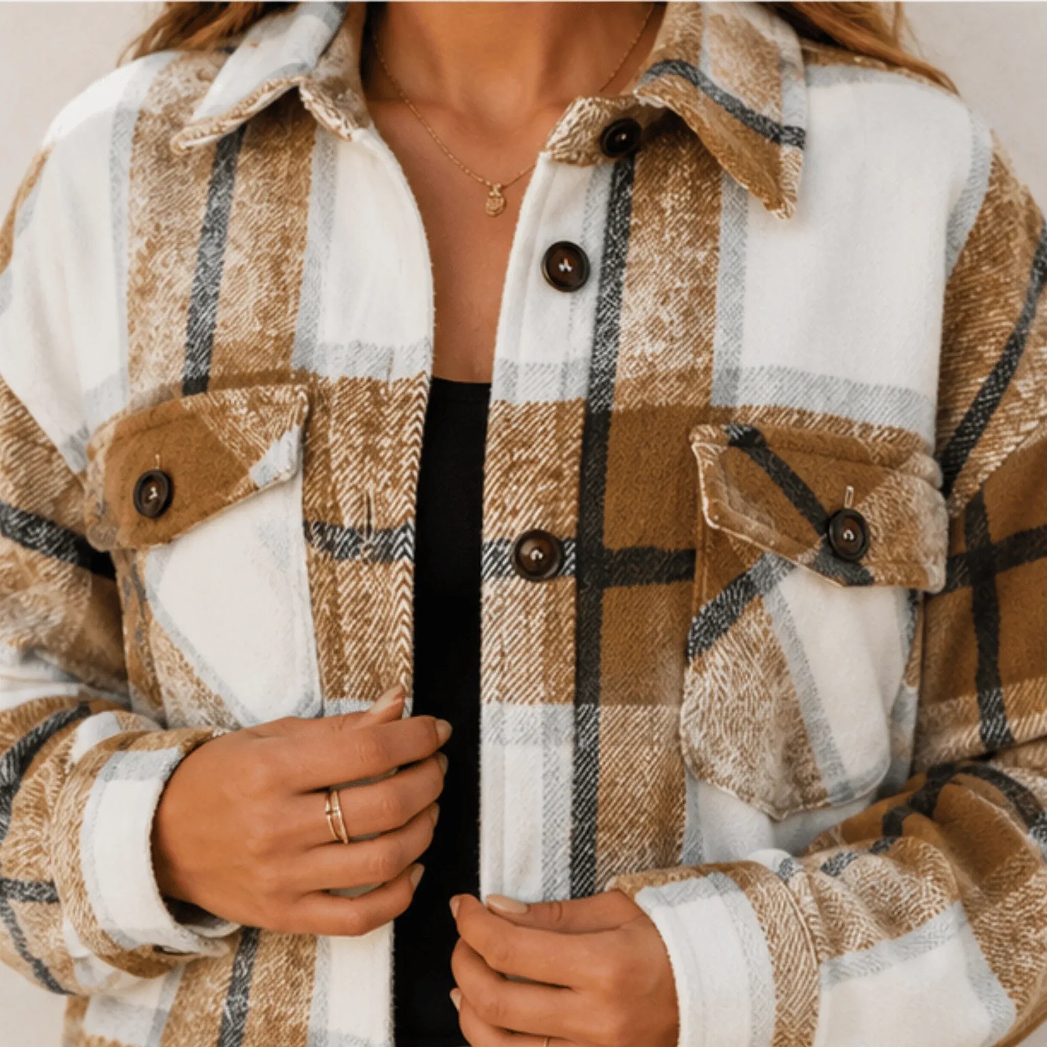 Close-up of the khaki plaid button down shacket highlighting the brushed fabric, button-front closure, chest pockets, and classic plaid pattern.