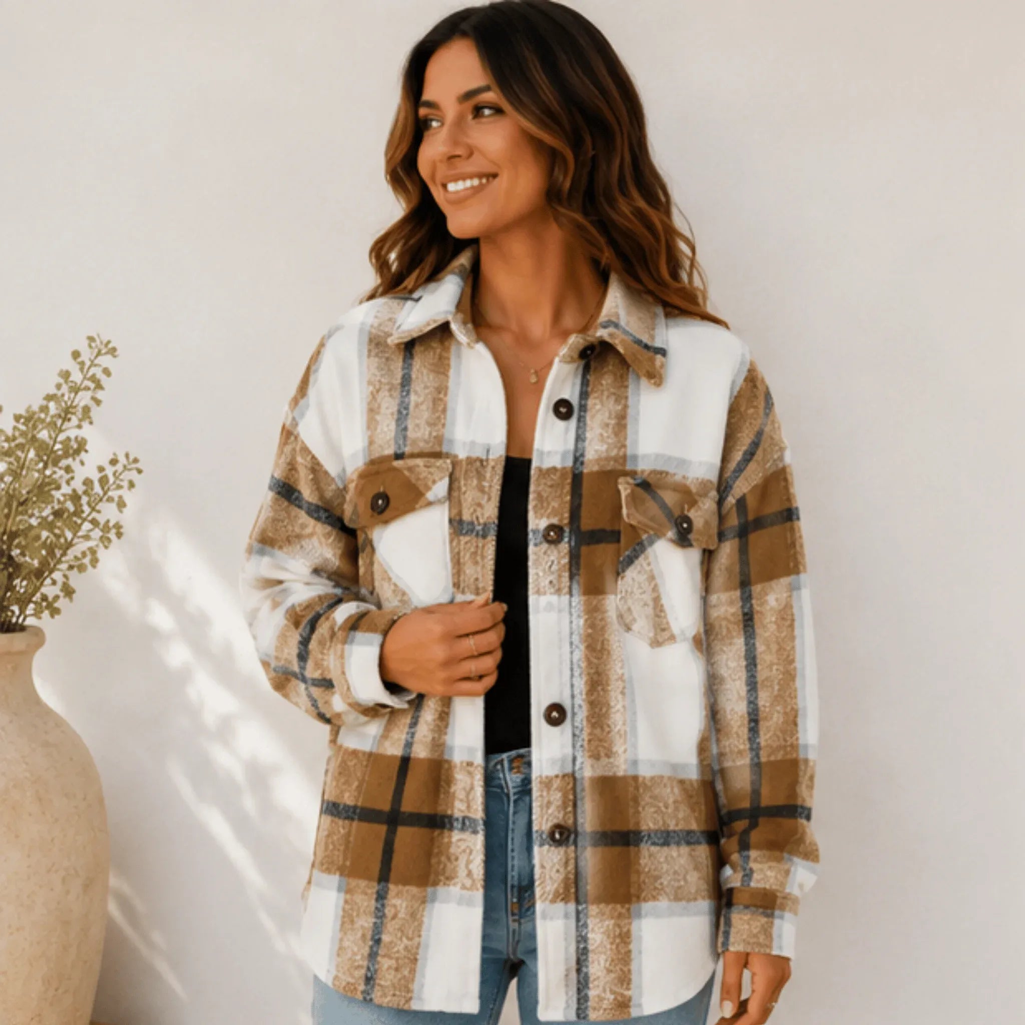 Women's khaki plaid button down shacket with an oversized silhouette, button-front closure, collared neckline, and front flap pockets.