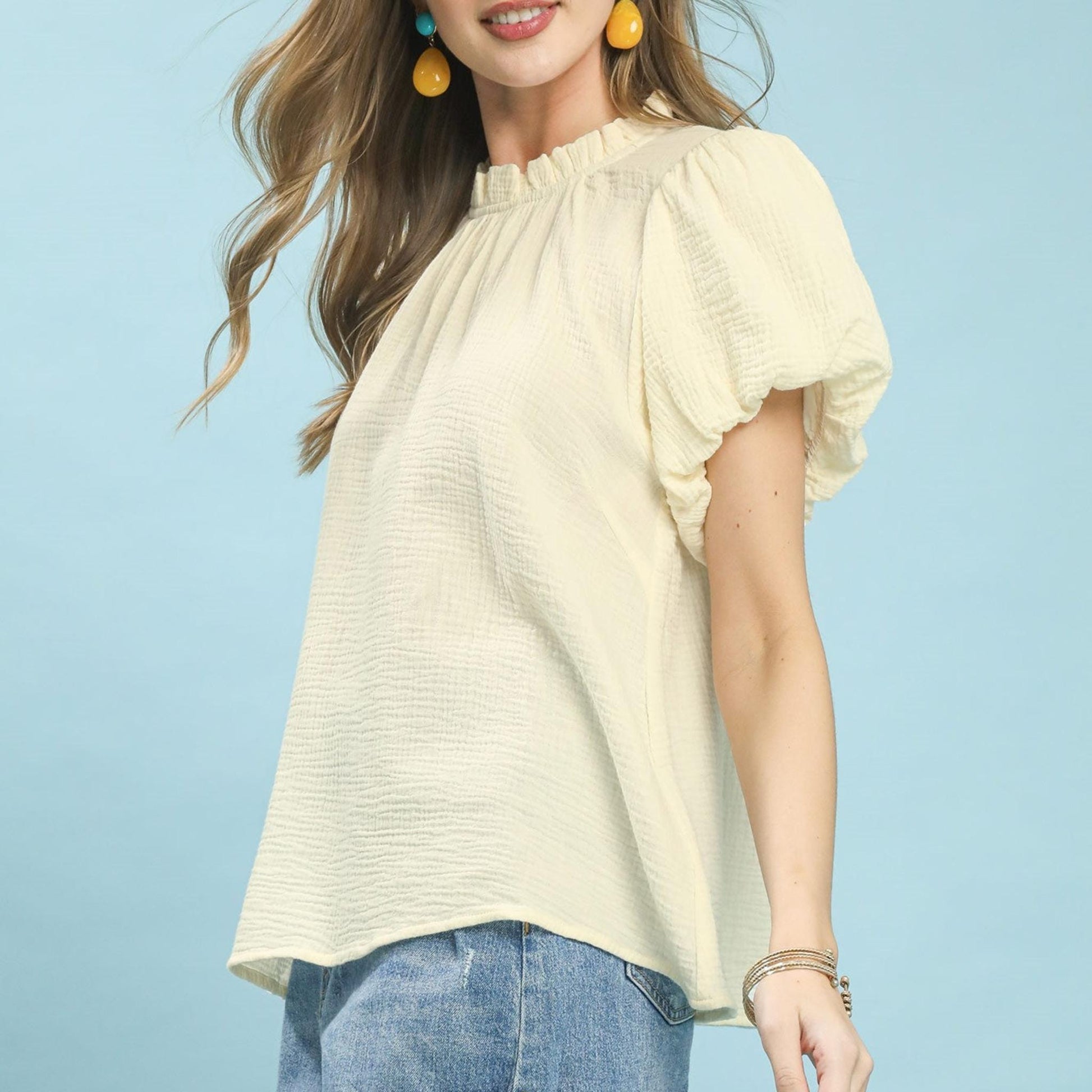 Lifestyle view of the Umgee gauze top paired with denim for a bohemian look.