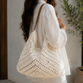Crochet Shoulder Bag With Pouch in natural featuring an open-knit woven design, faux leather shoulder straps, and a spacious boho silhouette carried over the shoulder.