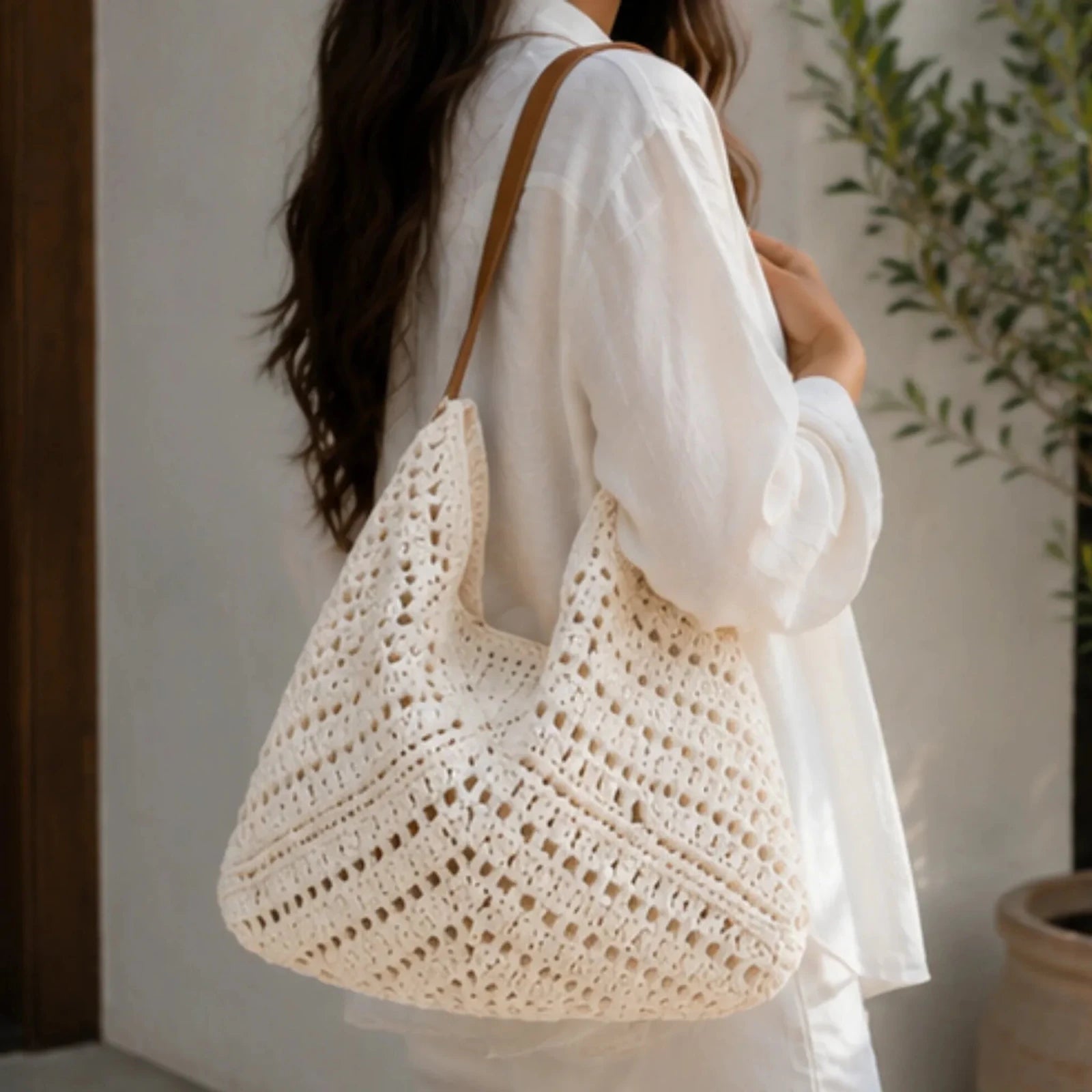 Crochet Shoulder Bag With Pouch in natural featuring an open-knit woven design, faux leather shoulder straps, and a spacious boho silhouette carried over the shoulder.