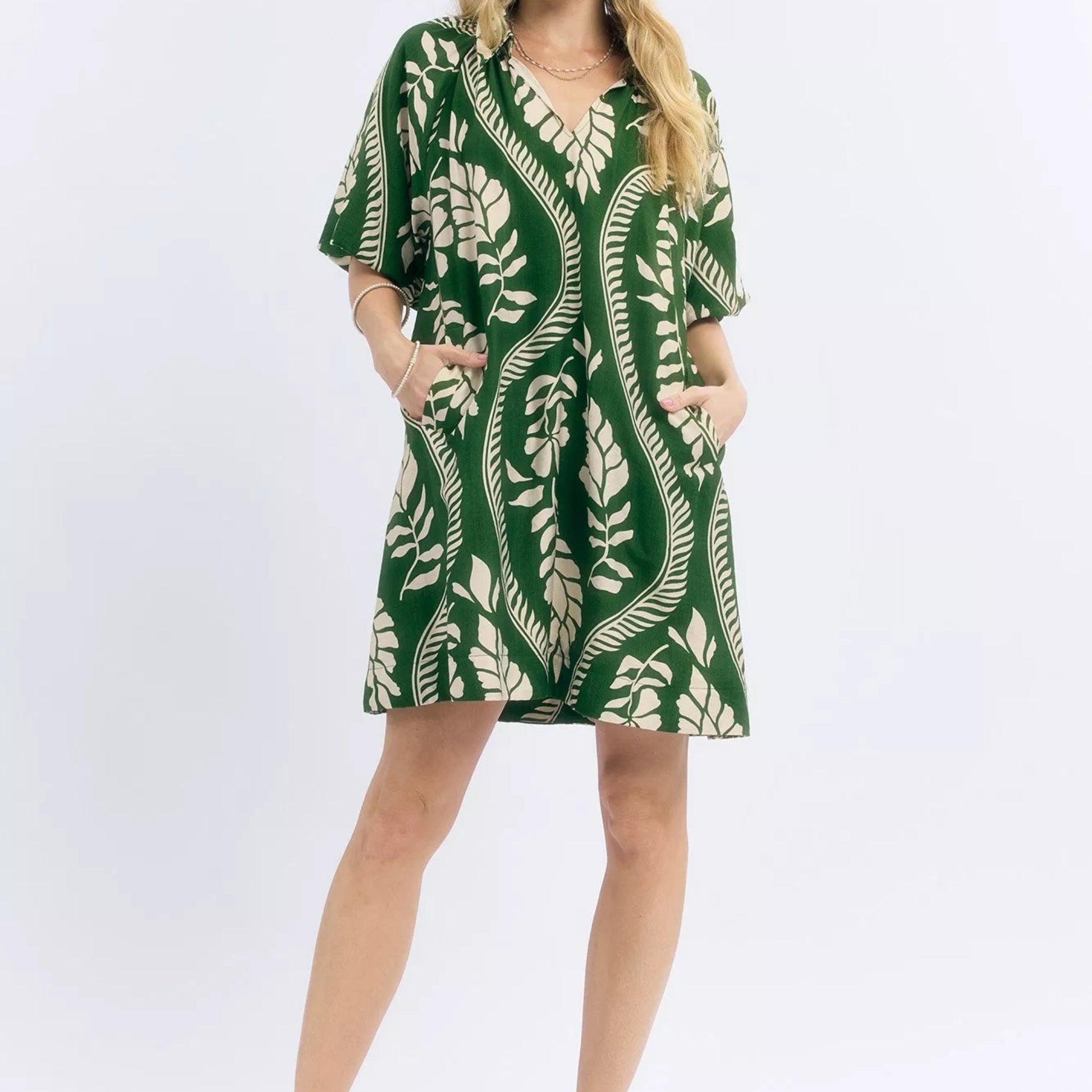 Model wearing a bohemian style cream and green Umgee leafy ogee print mini dress from Solazura Boutique