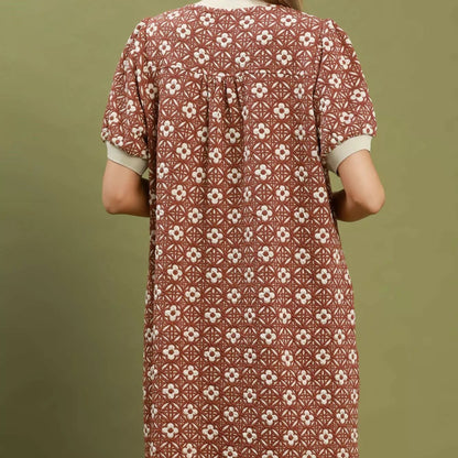 Close up detail of the elastic puff sleeve and textured rust floral fabric from Solazura Boutique