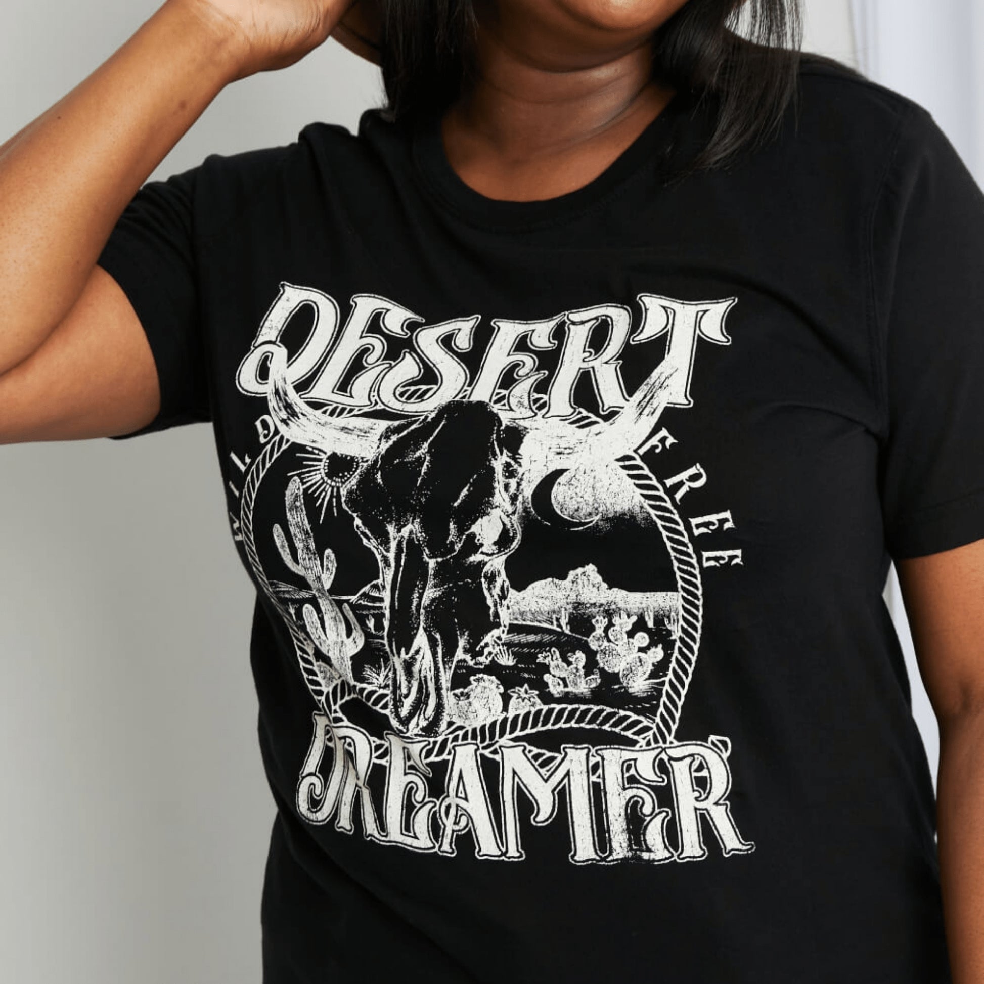 Close-up detail of the high-quality Desert Dreamer screen print on black cotton fabric.